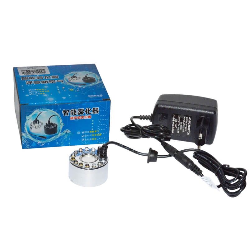 Generator de ceata cu 12 leduri 4 Generator de ceata cu 12 leduri este un Mist Maker ce simuleaza nori mici si ceata racoroasa. Generator de ceata cu ultrasunete, aparat ceata rece ce functioneaza in orice vas de apa (castroane de apa, cascade, etc), cu o adancime de minim 5 cm! Generator de ceata ce ridica deasupra apei nori de ceata si totodata creeaza un spectacol de lumini in apa – Genereaza o ceata racoroasa. Ideal pentru cresterea nivelului de umiditate si crearea unui mediu cetos natural si umed. Impreuna cu aceasta tehnologie, iluminarea cu leduri creaza o ambianta aparte. Functioneaza in orice vas de apa (castroane de apa, cascade, etc), cu o adancime de minim 5 cm! Sistemul de siguranta a dispozitivului nu permite functionarea acestuia (dispozitivul se opreste automat) in cazul in care nivelul apei scade sub 5 mm deasupra senzorului. • Aparat ceata rece ce creste nivelul de umiditate a aerului de pana la 100%. • Efect vizual deosebit. • Simuleaza nori mici si ceata in terarii tropicale. • Genereaza roua dimineata in terariile desertice. • Ledurile au capacitatea de a-si schimba automat culorile dand nastere unui spectacol unic in combinatie cu ceata generata. Generatorul de ceata ultrasonic este un dispozitiv sigur, eficient si numai cu efecte benefice pentru crearea unui mediu cat mai aproape de conditiile naturale in care traiesc reptilele. Acest generator de ceata cu ultrasunete poate fi folosit de asemenea in orice incapere ca umidificator sau in scop pur si simplu decorativ. Dispozitivul utilizeaza cca 80ml apa/ora, la o temperatura de lucru de temperatura de lucru 5 °C – 40 °C. Silentios: difuzorul de ceata prin tehnologia ultrasonica silentioasa iti va respecta linistea. Specialitatea lui este de a creea o atmosfera relaxanta. Dimensiuni – 38 mm inaltime x 44 mm diametru