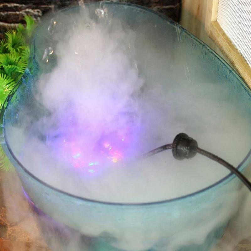 Generator de ceata cu 12 leduri 9 Generator de ceata cu 12 leduri este un Mist Maker ce simuleaza nori mici si ceata racoroasa. Generator de ceata cu ultrasunete, aparat ceata rece ce functioneaza in orice vas de apa (castroane de apa, cascade, etc), cu o adancime de minim 5 cm! Generator de ceata ce ridica deasupra apei nori de ceata si totodata creeaza un spectacol de lumini in apa – Genereaza o ceata racoroasa. Ideal pentru cresterea nivelului de umiditate si crearea unui mediu cetos natural si umed. Impreuna cu aceasta tehnologie, iluminarea cu leduri creaza o ambianta aparte. Functioneaza in orice vas de apa (castroane de apa, cascade, etc), cu o adancime de minim 5 cm! Sistemul de siguranta a dispozitivului nu permite functionarea acestuia (dispozitivul se opreste automat) in cazul in care nivelul apei scade sub 5 mm deasupra senzorului. • Aparat ceata rece ce creste nivelul de umiditate a aerului de pana la 100%. • Efect vizual deosebit. • Simuleaza nori mici si ceata in terarii tropicale. • Genereaza roua dimineata in terariile desertice. • Ledurile au capacitatea de a-si schimba automat culorile dand nastere unui spectacol unic in combinatie cu ceata generata. Generatorul de ceata ultrasonic este un dispozitiv sigur, eficient si numai cu efecte benefice pentru crearea unui mediu cat mai aproape de conditiile naturale in care traiesc reptilele. Acest generator de ceata cu ultrasunete poate fi folosit de asemenea in orice incapere ca umidificator sau in scop pur si simplu decorativ. Dispozitivul utilizeaza cca 80ml apa/ora, la o temperatura de lucru de temperatura de lucru 5 °C – 40 °C. Silentios: difuzorul de ceata prin tehnologia ultrasonica silentioasa iti va respecta linistea. Specialitatea lui este de a creea o atmosfera relaxanta. Dimensiuni – 38 mm inaltime x 44 mm diametru